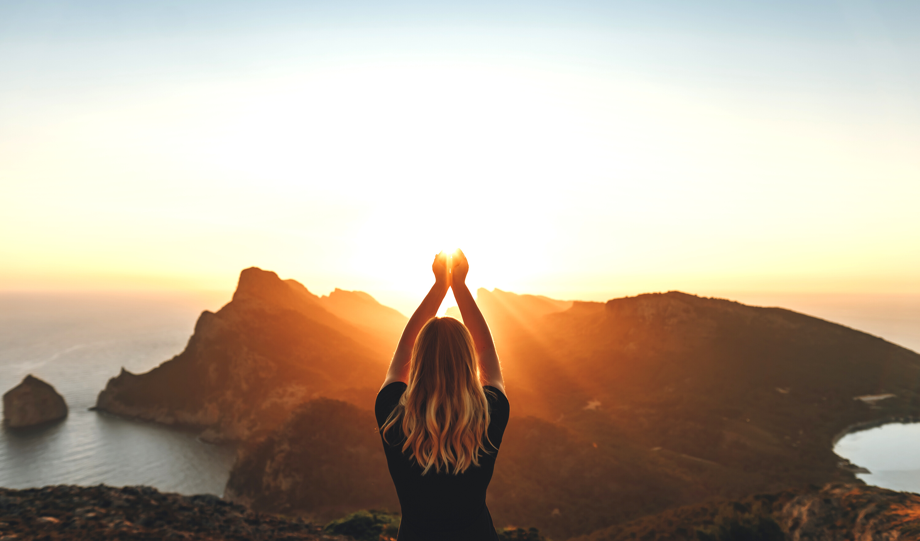 Young woman in spiritual pose holding the light